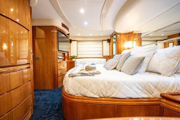 Slide: The Image of Luxurious bedroom interior of 2003 Azimut 80 Carat yacht with elegant wood finishes. - 34