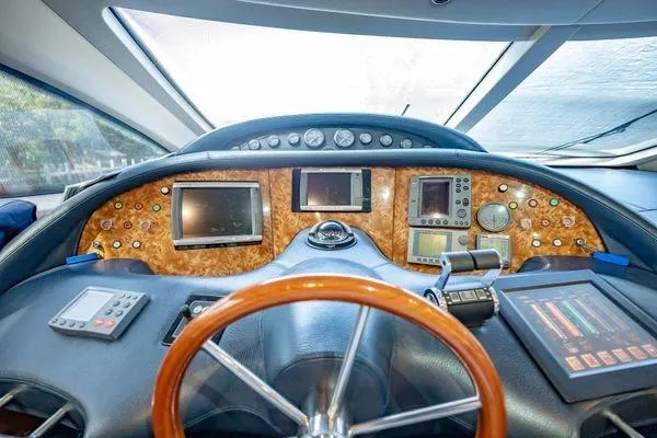 Slide: The Image of Cockpit of 2003 Azimut 80 Carat yacht with advanced navigation instruments and wooden steering wheel. - 35