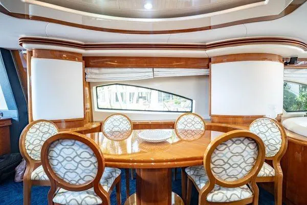 Slide: The Image of Luxurious dining area on 2003 Azimut 80 Carat yacht with elegant wooden table and chairs. - 46
