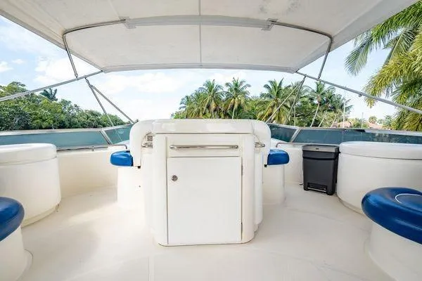 Slide: The Image of Flybridge of 2003 Azimut 80 Carat yacht with seating and tropical backdrop. - 54