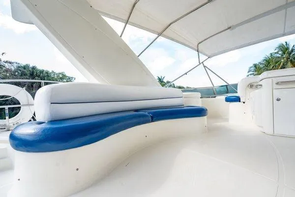 Slide: The Image of Luxurious seating area on 2003 Azimut 80 Carat yacht with blue and white cushions. - 55