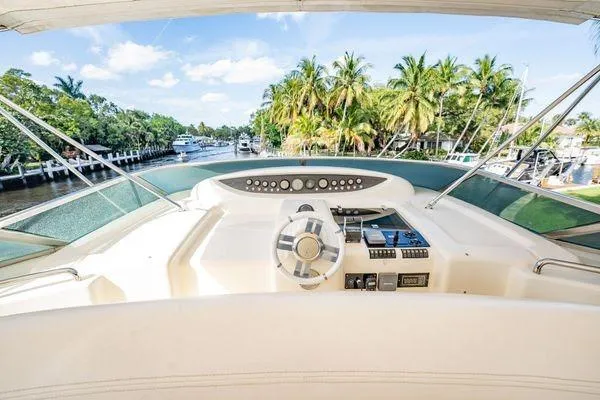 Slide: The Image of Cockpit view of 2003 Azimut 80 Carat yacht with tropical waterfront backdrop. - 57