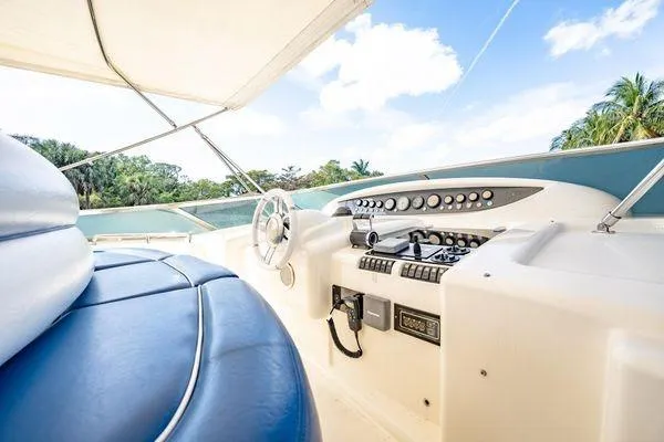 Slide: The Image of Luxurious 2003 Azimut 80 Carat yacht helm with blue seating and tropical backdrop. - 58