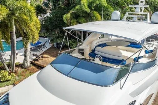 Slide: The Image of Luxury 2003 Azimut 80 Carat yacht docked near tropical poolside setting. - 59