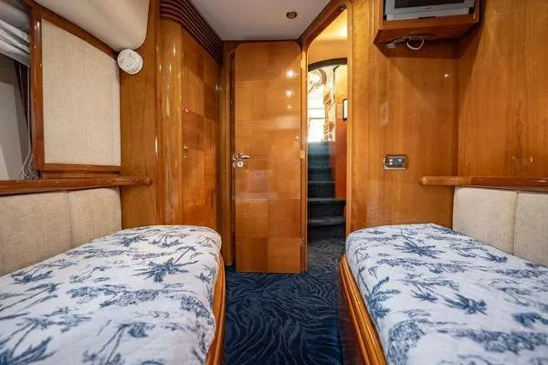 Slide: The Image of Luxurious 2003 Azimut 80 Carat yacht cabin with twin beds and elegant wood paneling. - 7