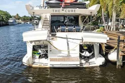 Slide: The Image of 2003 Azimut 80 Carat yacht docked in a scenic marina setting. - 75