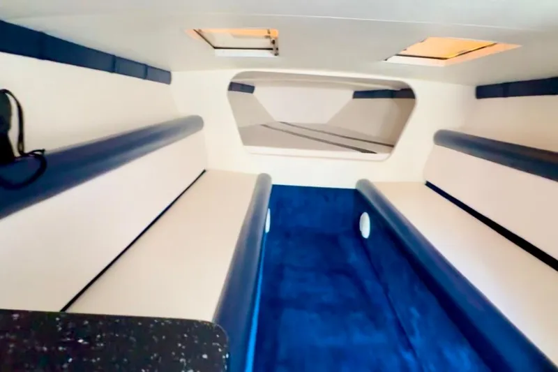 Slide: The Image of Interior of 2015 Donzi 38 ZR boat with blue and white seating. - 11