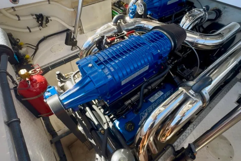 Slide: The Image of 2015 Donzi 38 ZR engine compartment with Mercury engines and chrome exhaust. - 18