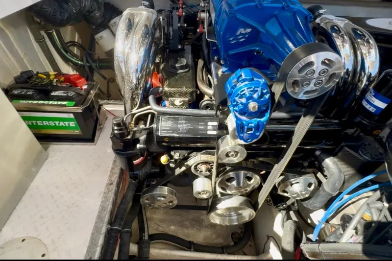 Slide: The Image of Engine compartment of a 2015 Donzi 38 ZR boat, featuring a powerful motor and battery. - 21