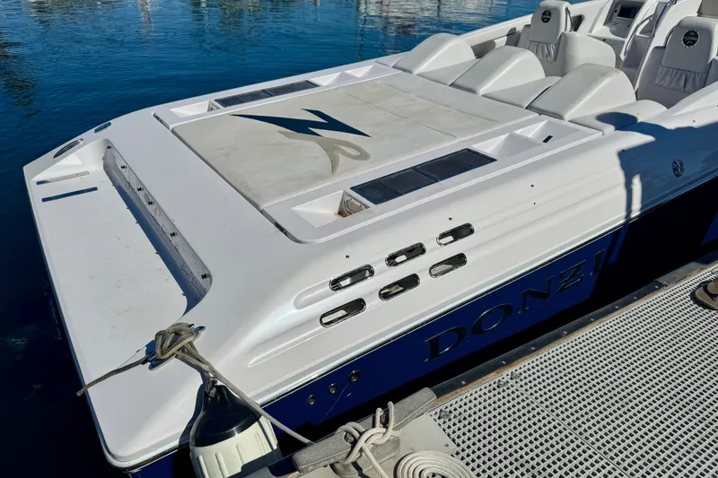 Slide: The Image of 2015 Donzi 38 ZR speedboat docked, featuring sleek design and comfortable seating. - 4