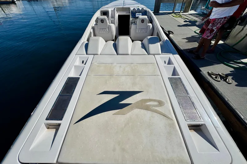 Slide: The Image of 2015 Donzi 38 ZR speedboat docked, featuring sleek design and comfortable seating. - 5