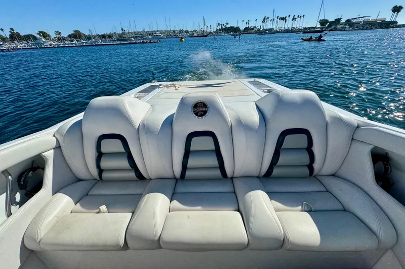 Slide: The Image of 2015 Donzi 38 ZR boat interior with white seating, cruising on a sunny day. - 6