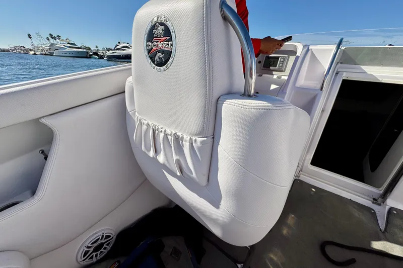 Slide: The Image of Interior of a 2015 Donzi 38 ZR boat with white seating and logo. - 8