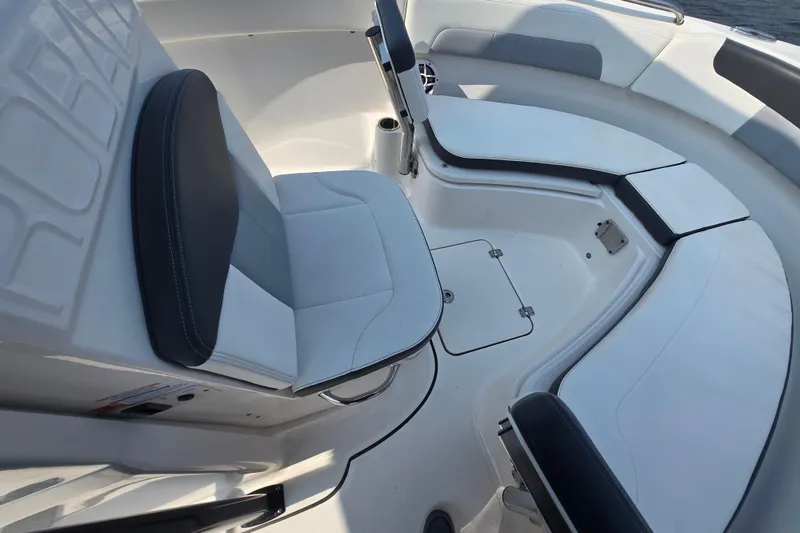 Slide: The Image of 2022 Robalo R222 Center Console boat interior with cushioned seating and storage compartments. - 11