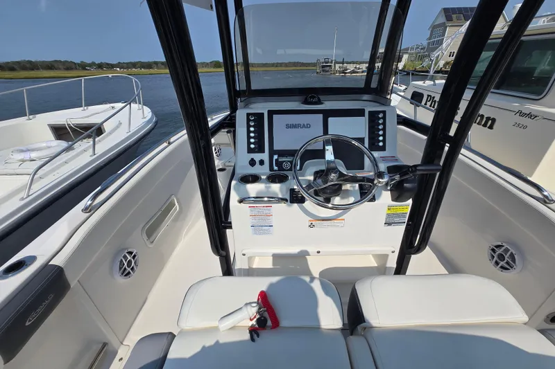 Slide: The Image of 2022 Robalo R222 Center Console boat interior with steering wheel and control panel. - 15