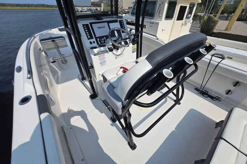 Slide: The Image of 2022 Robalo R222 Center Console boat interior with steering wheel and seating. - 19