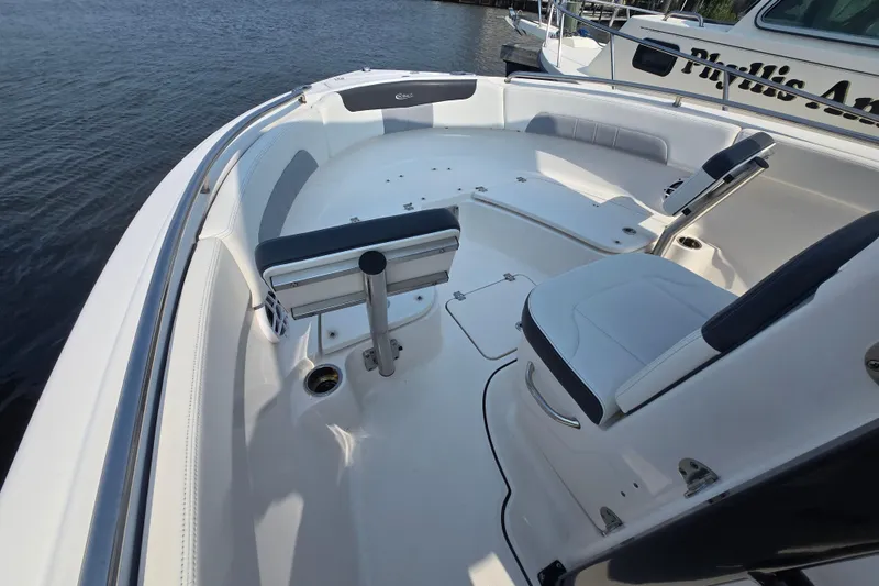 Slide: The Image of 2022 Robalo R222 Center Console boat interior with seating, on calm water. - 20