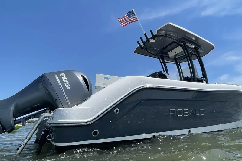 Slide: The Image of 2022 Robalo R222 Center Console boat with Yamaha engine on water. - 22
