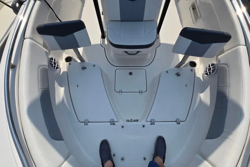 Slide: The Image of 2022 Robalo R222 Center Console boat interior with seating and storage compartments. - 23