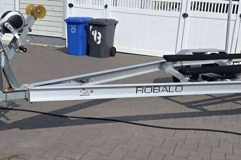 Slide: The Image of Trailer for 2022 Robalo R222 Center Console boat on paved driveway. - 27