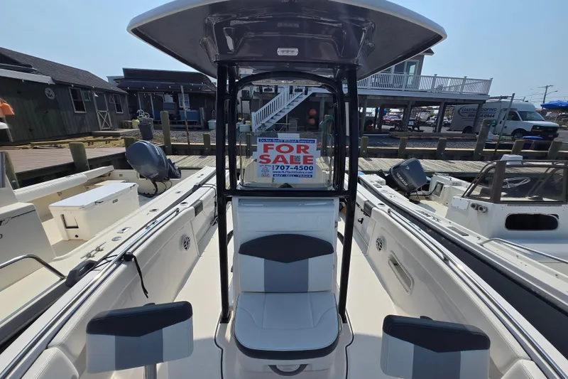 Slide: The Image of 2022 Robalo R222 Center Console boat for sale at a marina dock. - 5