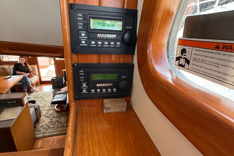 Slide: The Image of Interior of 1998 Kadey-Krogen 48' Northsea Pilothouse with control panels and warning sign. - 17