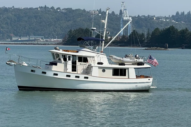 Slide: The Image of 1998 Kadey-Krogen 48' Northsea Widebody Pilothouse yacht on calm water, scenic background. - 0