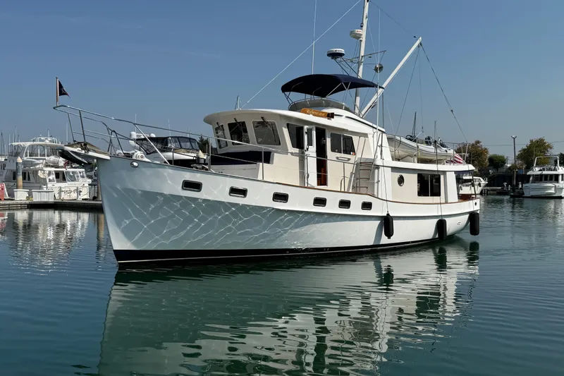Slide: The Image of 1998 Kadey-Krogen 48' Northsea Widebody Pilothouse yacht docked in a marina. - 1