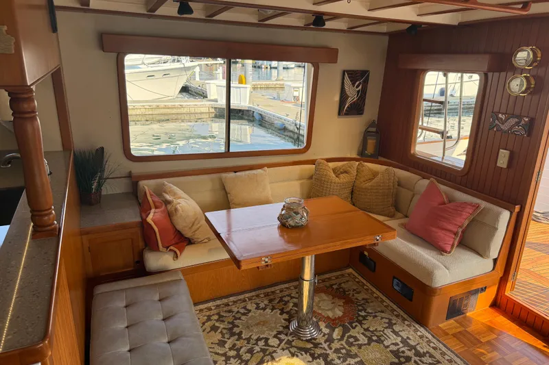 Slide: The Image of Cozy interior of 1998 Kadey-Krogen 48' Northsea Widebody Pilothouse with plush seating and wooden accents. - 12