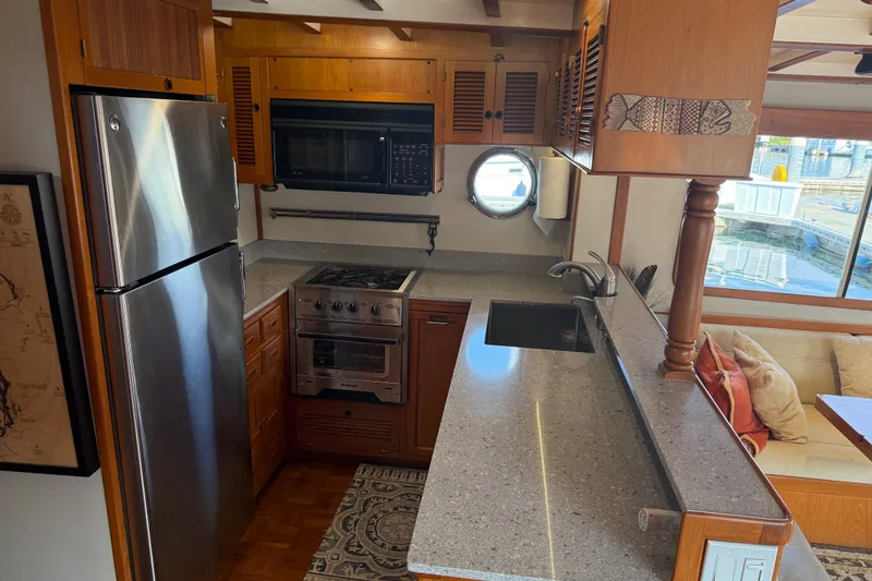 Slide: The Image of 1998 Kadey-Krogen 48' Northsea Widebody Pilothouse kitchen with modern appliances and cozy seating area. - 15