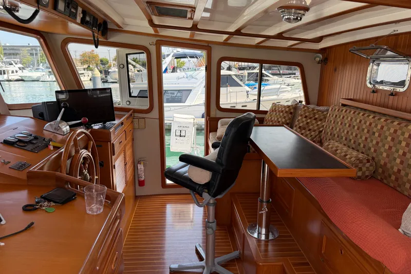 Slide: The Image of 1998 Kadey-Krogen 48' Northsea Widebody Pilothouse interior with helm, seating, and table. - 16