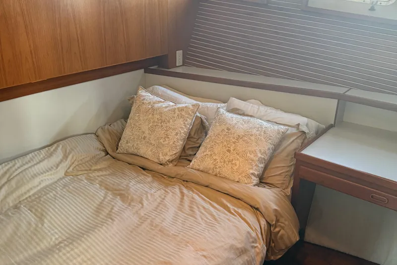 Slide: The Image of Cozy bedroom in 1998 Kadey-Krogen 48' Northsea Widebody Pilothouse yacht with elegant bedding. - 25