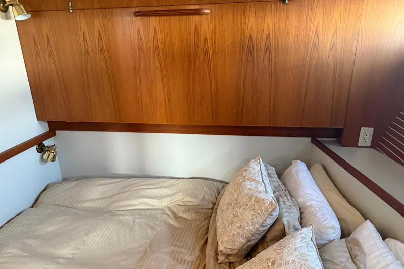 Slide: The Image of Cozy bedroom in 1998 Kadey-Krogen 48' Northsea Widebody Pilothouse with wood paneling and elegant bedding. - 26