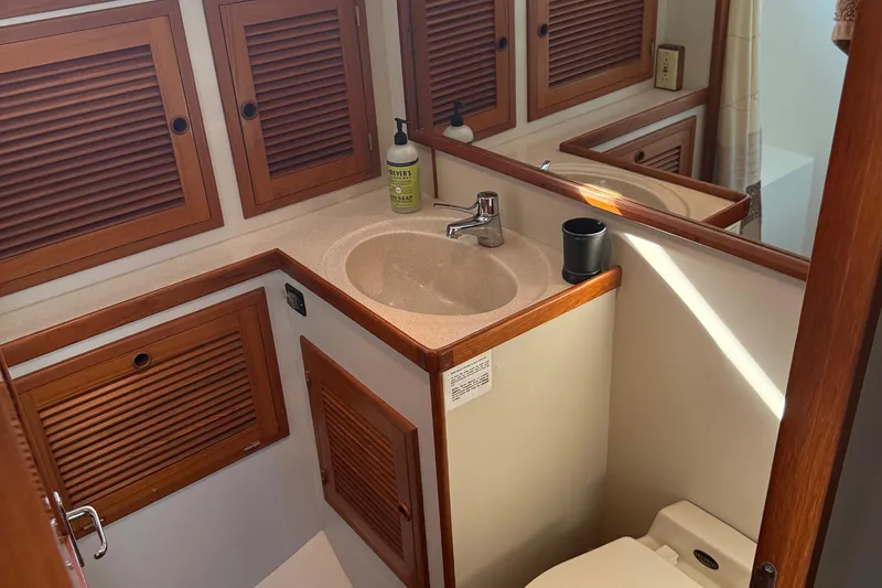 Slide: The Image of Bathroom interior of 1998 Kadey-Krogen 48' Northsea Widebody Pilothouse with wooden cabinetry. - 28