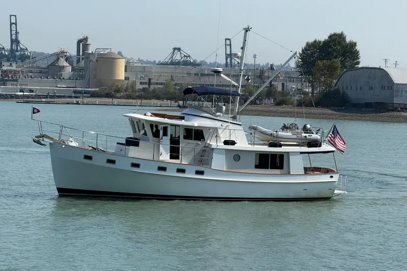 Slide: The Image of Kadey-Krogen 48' Northsea Widebody Pilothouse yacht, 1998, cruising on calm waters near industrial backdrop. - 40