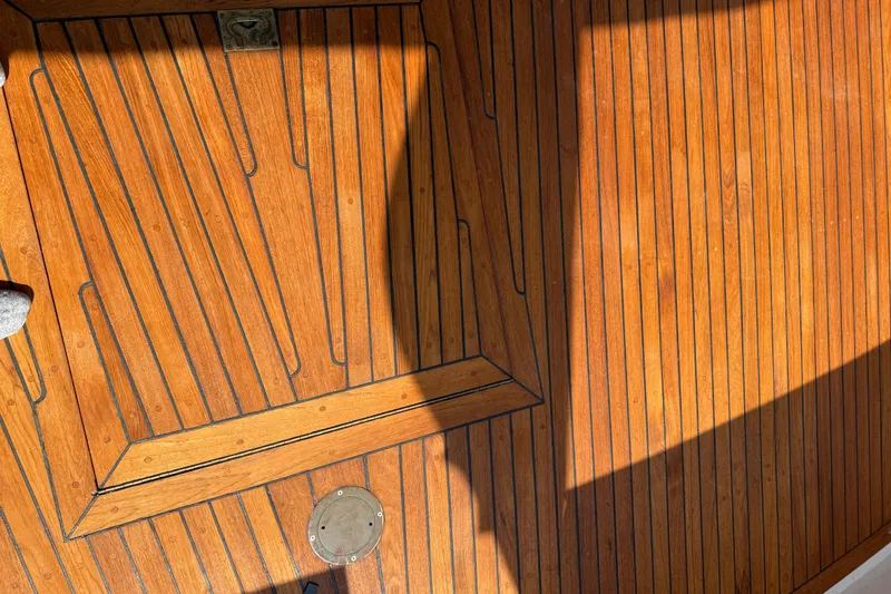Slide: The Image of Teak deck of 1998 Kadey-Krogen 48' Northsea Widebody Pilothouse, showcasing wood grain and shadows. - 7