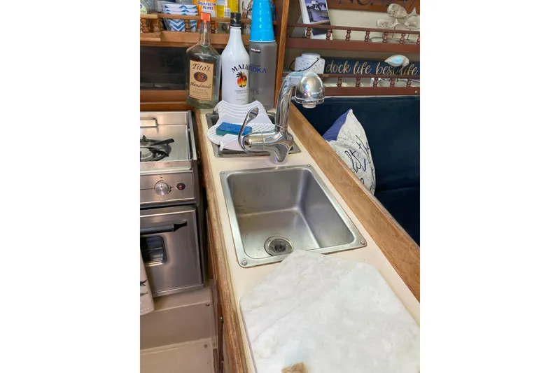 Slide: The Image of galley sinks and counter. Convenient trash container built in to counter - 10