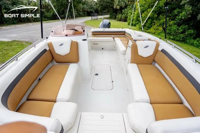 Slide: The Image of 2022 Starcraft SVX 191 OB boat interior with tan and white seating, outdoor setting. - 6