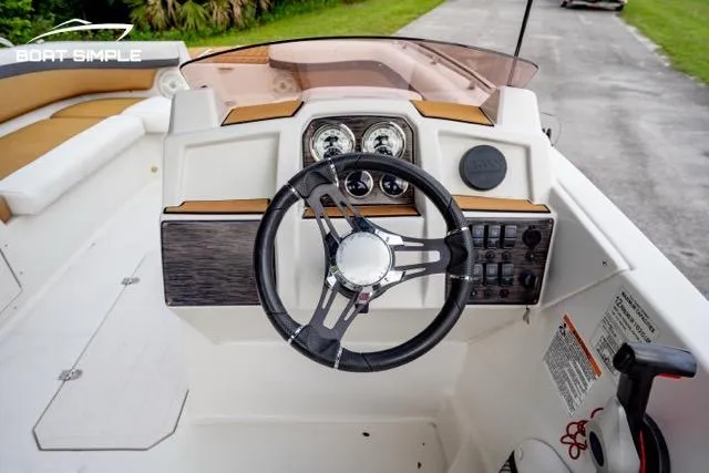 Slide: The Image of 2022 Starcraft SVX 191 OB boat dashboard with steering wheel and control panel. - 7