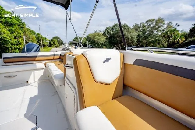 Slide: The Image of 2022 Starcraft SVX 191 OB boat interior with tan and white seating, outdoor setting. - 9