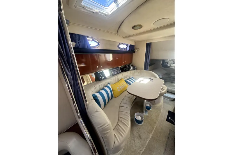 Slide: The Image of Interior of 2002 Sea Ray 340 Sundancer yacht with cozy seating and table. - 13