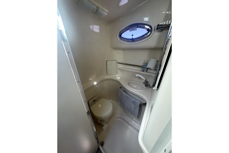 Slide: The Image of Compact bathroom in 2002 Sea Ray 340 Sundancer yacht with porthole and sink. - 15