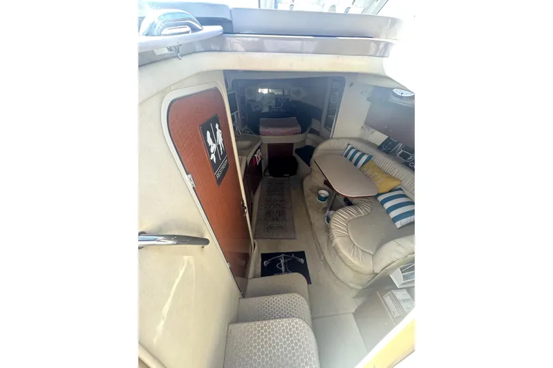 Slide: The Image of Interior of 2002 Sea Ray 340 Sundancer yacht with cozy seating and nautical decor. - 16