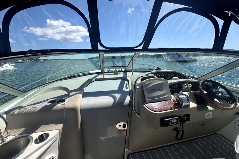 Slide: The Image of Cockpit view of 2002 Sea Ray 340 Sundancer yacht with Garmin navigation, on a sunny day. - 3