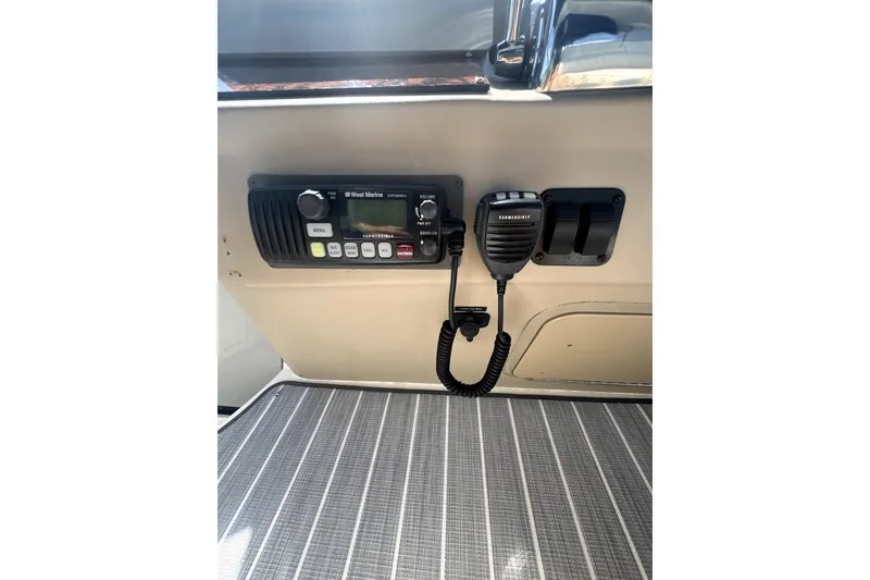 Slide: The Image of 2002 Sea Ray 340 Sundancer radio and microphone on boat dashboard. - 6
