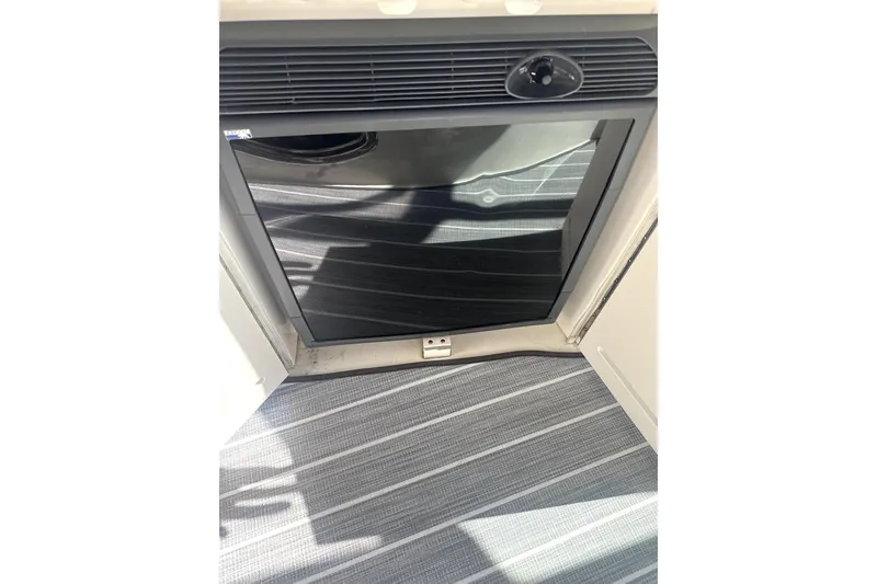 Slide: The Image of Mini fridge on 2002 Sea Ray 340 Sundancer yacht, with striped flooring. - 9
