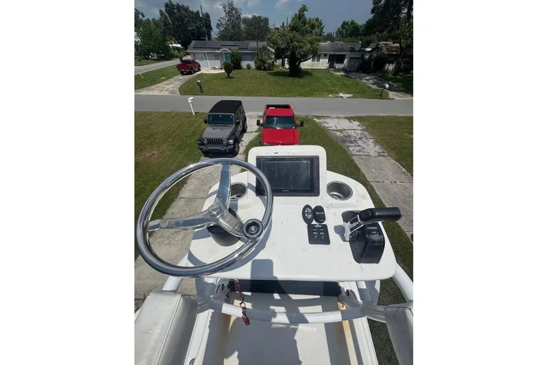 Slide: The Image of 2016 Sea Hunt BX 24 BR boat console with steering wheel and controls. - 11