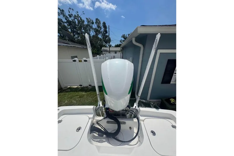 Slide: The Image of 2016 Sea Hunt BX 24 BR boat engine with dual power poles in a residential setting. - 13