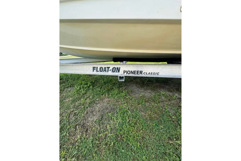 Slide: The Image of 2016 Sea Hunt BX 24 BR boat on Float-On Pioneer Classic trailer, grassy background. - 14