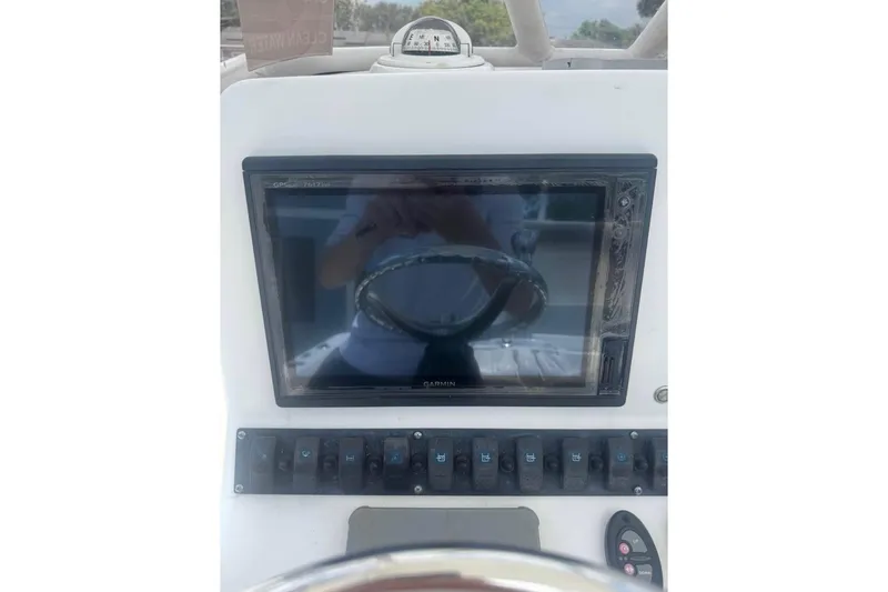 Slide: The Image of 2016 Sea Hunt BX 24 BR boat dashboard with Garmin GPS and control panel. - 6